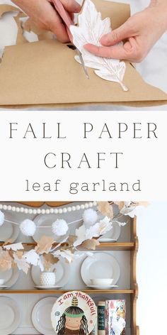 paper craft leaf garland on top of a cardboard box with white plates and napkins