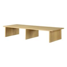 a wooden bench sitting on top of a white wall