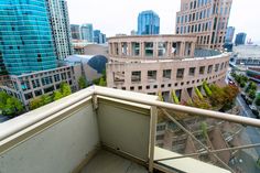 a balcony with city buildings in the background