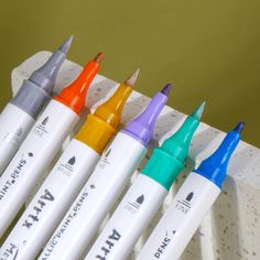 six markers are lined up in a row