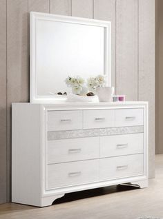 a white dresser and mirror in a room