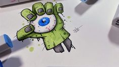 a drawing of a zombie hand with blue eyes