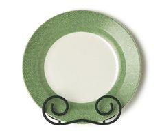 a green and white plate with two black handles on the rim, against a white background