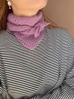 a woman wearing a striped shirt with a pink knitted cowgirl scarf on her neck