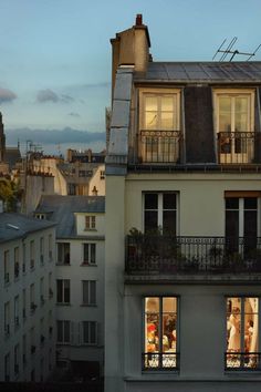 an apartment building with two balconies at dusk