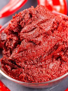 a bowl filled with red colored food on top of a table