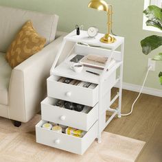 a living room with a white couch and some drawers on the floor next to a coffee table