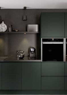 A kitchen created for those who appreciate minimalism, it offers both efficiency and luxury in one. Statement Kitchen, Green Kitchen Designs, Dark Green Kitchen, Handleless Kitchen, Green Kitchen Cabinets, Dark Kitchen, Design Your Kitchen, Kitchen Room Design, Kitchen Inspiration Design