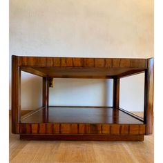 a wooden shelf sitting on top of a hard wood floor