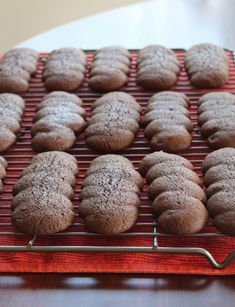 chocolate cookies are cooling on a wire rack