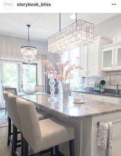 an instagram photo of a kitchen island with chairs