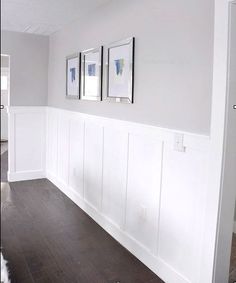 two framed pictures on the wall in a white room with wood floors and hard wood flooring