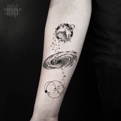 a person with a black and white tattoo on their arm that has an image of the planets