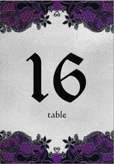 the table number is decorated with purple and black lace