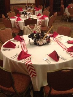 the table is set with red and white napkins, silverware, and candy canes