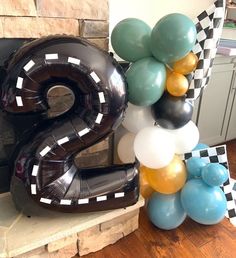 balloons are arranged in the shape of numbers on top of a table with a fireplace