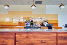 an empty bar with several lights hanging above it