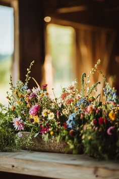 colorful flowers are arranged on a wooden table