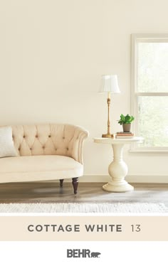 a living room with a couch, table and lamp in it's centerpiece