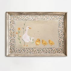 an embroidered picture frame with ducks and chicks