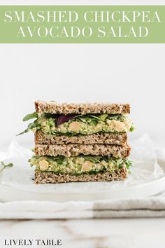 the vegan smashed chickpea and avocado salad sandwich is stacked on top of each other