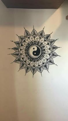 a wall with a yin sign painted on it and a black ball in the middle