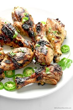 grilled chicken with green peppers on a white plate