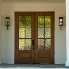 two wooden doors with glass panels on the outside