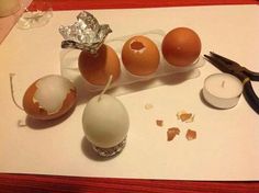 an assortment of eggs sitting on top of a table next to a pair of scissors