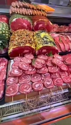 many different types of meats and vegetables on display