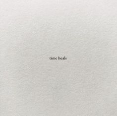 the word time heals written in white paper