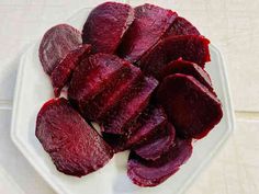 sliced beets sit on a white plate