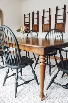 a dining room table with four chairs around it