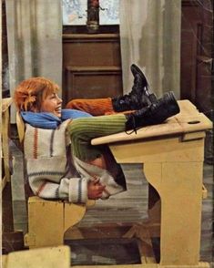 a woman laying on top of a wooden table