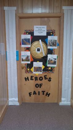 a door decorated with pictures and words that say, hero of faith on the front