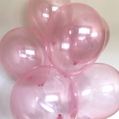 pink balloons are arranged on a white surface