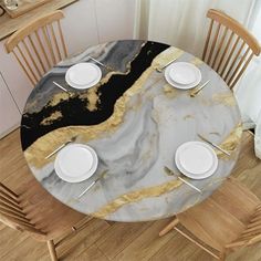 a marble table with white plates and silverware on it