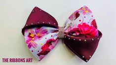 a bow tie with flowers on it and a small broochie in the background