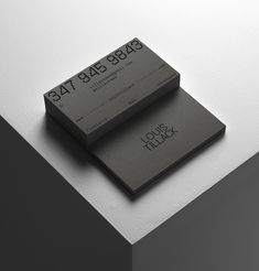 two business cards sitting on top of each other