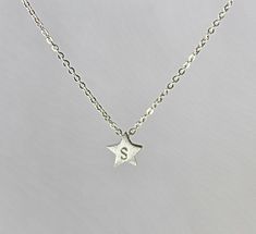 "A tiny star, hand stamped with personalized initial, sweet and cute. Or you can have the star without initial, the plain lucky star. Sterling silver star measures about 7 mm, with brushed finish. Leave a message in \"Note to Fabulouswire\" when you place your order if you choose to have an initial stamped. Customized sterling silver chain length can be selected from 12\" to 18\". All components are 925 sterling silver." Personalized Sterling Silver Star Charm Necklace, Everyday Personalized Star-shaped Jewelry, Cute Silver Star Jewelry, Personalized Silver Star Charm Necklace, Silver Star-shaped Personalized Necklace, Personalized Silver Star Necklace, Dainty Star-shaped Personalized Necklace, Dainty Personalized Star Necklace, Personalized Star-shaped Birthday Jewelry