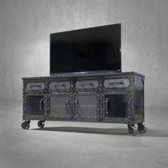 an entertainment center with wheels and a flat screen tv mounted on it's side