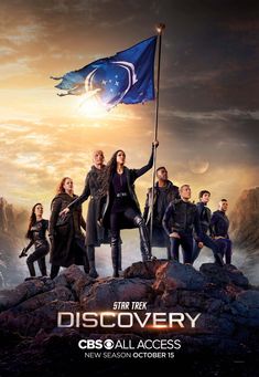 the star trek discovery poster is shown with many people standing on rocks and holding a flag