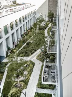 an aerial view of a building with many plants growing on the roof and walkways