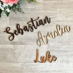 wooden name cutouts with flowers on the floor