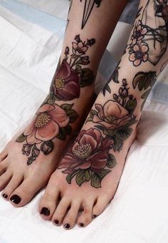 a woman's feet with flowers and birds on them