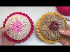 two crocheted baskets are shown with yarn in the middle and one has a button on it