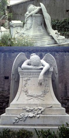 an angel statue sitting in front of a grave