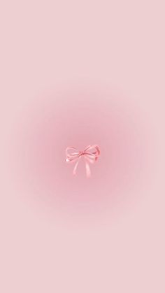 a pink wall with a bow on the top and one side that is slightly open