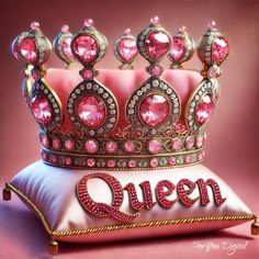 a pink crown sitting on top of a pillow with the word queen spelled in gold