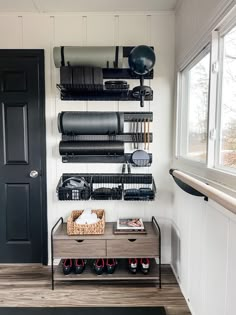 a black door and some shelves in a room